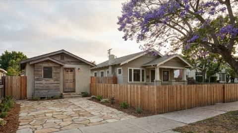 A small detached ADU cottage behind a single-story bungalow on a narrow Santa Monica lot