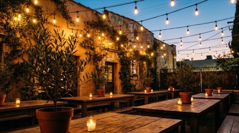 An empty outdoor restaurant patio in Los Feliz strung with lights at dusk
