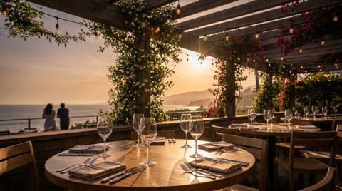 An upscale outdoor restaurant patio in Santa Monica with string lights at golden hour