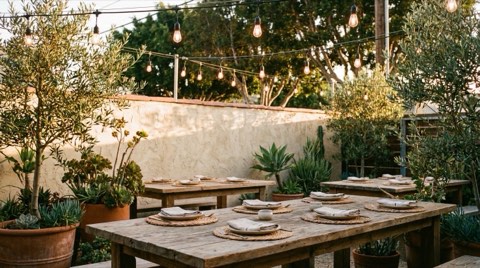 An empty outdoor restaurant patio in Venice with string lights at golden hour