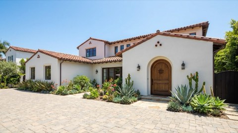 An elegant Spanish Colonial style single-family home exterior in Santa Monica under a clear blue sky