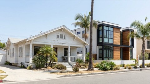 A whitewashed craftsman bungalow next to a modern architectural home on a Venice block