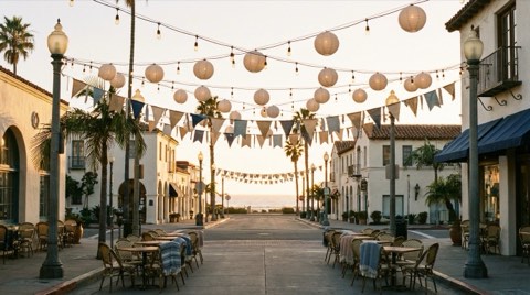 A small-town beach community street strung with lights and bunting for a local community event