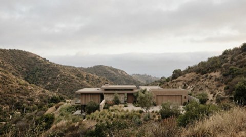 Hillside Los Angeles neighborhood beneath a hazy afternoon sky