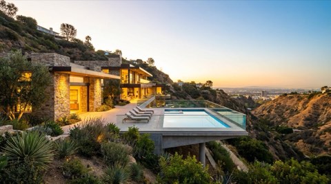 Cantilevered hillside estate deck overlooking an LA canyon at sunset