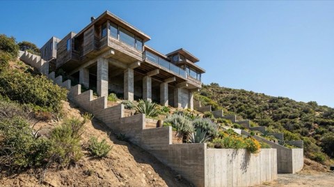 A Los Feliz hillside home supported by engineered retaining walls and concrete pilings on a steep slope