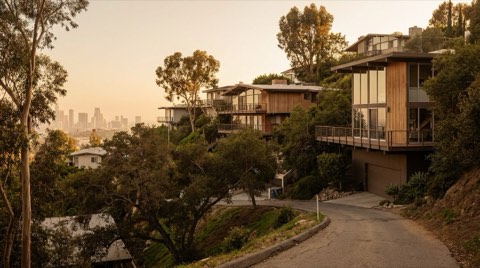 Hollywood Hills hillside home with a city skyline hazy below