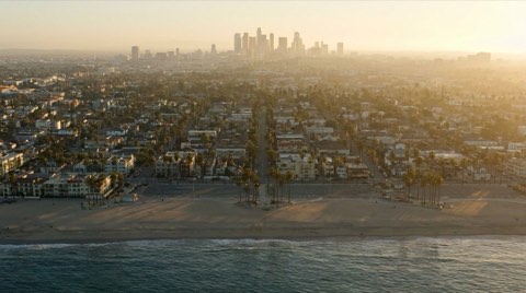 A wide view of the Venice coastline with the downtown LA skyline in the distance
