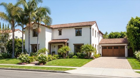 A traditional Beverlywood home exterior with a two-car garage and manicured front lawn in bright daylight