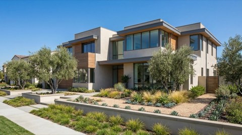 An upscale modern townhome exterior with clean contemporary architecture, large windows, and manicured landscaping under bright daylight.