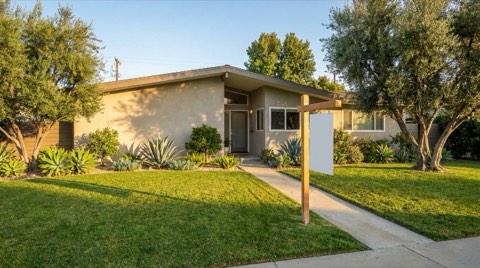 A well-maintained single-family home in Studio City with a neatly mowed lawn at golden hour