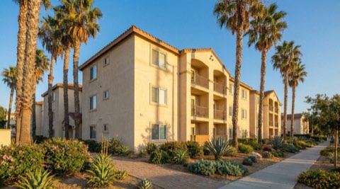 Small multi-family apartment building with palm trees in Los Angeles