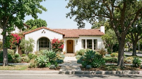 A well-maintained traditional single-family home in Beverlywood with tidy landscaping in bright midday sun