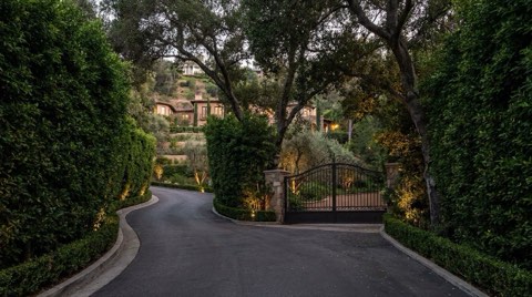 A discreet gated driveway leading to a hillside estate in Studio City at dusk