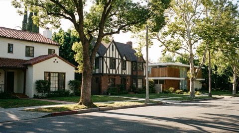 A Los Feliz street showing a Spanish revival, a Tudor, and a mid-century modern home side by side