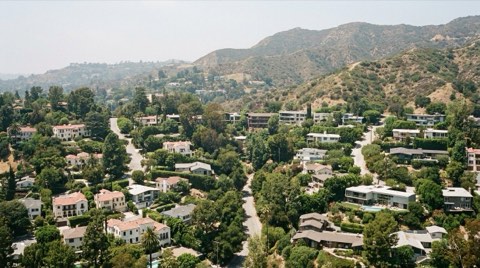An elevated view over the Los Feliz hillside showing distinct home pockets divided by winding roads and tree canopy