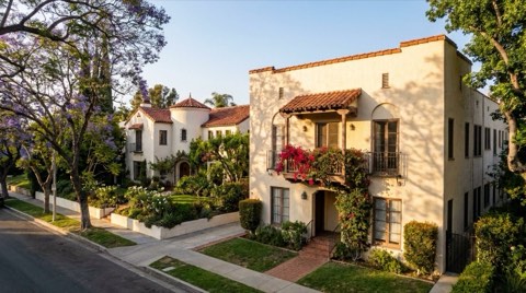 A small Los Feliz apartment building beside a single-family Spanish home on the same tree-lined street