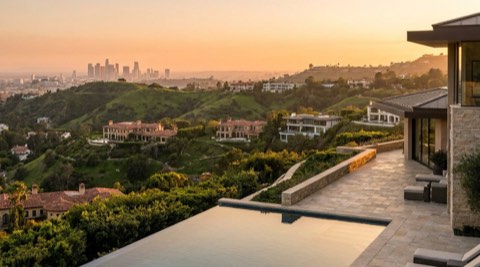 Sweeping hillside view of Los Angeles homes and skyline at golden hour