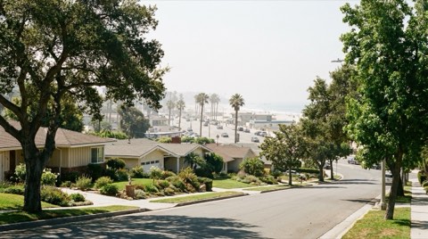 A quiet residential Mar Vista street contrasted with a busier beach-adjacent street in the distance