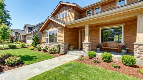 A beautifully staged single-family home exterior ready for an open house in bright sunny midday light