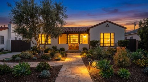 A beautifully staged single-family home exterior in Studio City with glowing windows at dusk