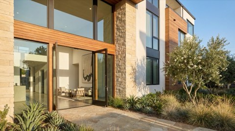 A bright modern condo building entrance with clean architectural lines and fresh landscaping, suggesting a fresh start.