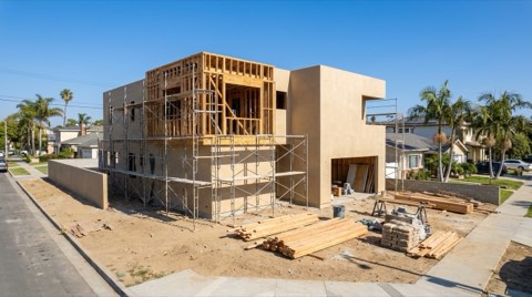 A near-complete new home construction site in Beverlywood with wood framing and finished stucco walls