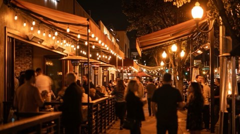 A Ventura Boulevard nightlife scene in Studio City at night with glowing bar patio lights