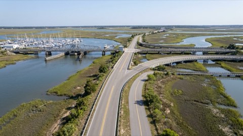 A bike path near a marina and coastal wetlands waterway used for commuting