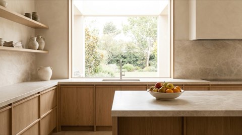 Clean, decluttered kitchen counter with fresh fruit and soft daylight