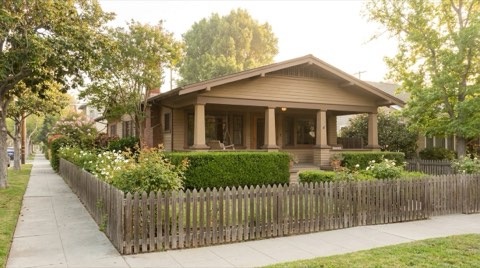 A classic 1920s California bungalow home exterior in Santa Monica in soft morning light