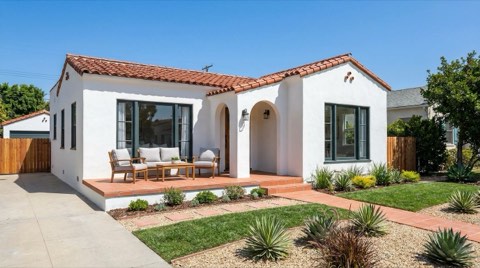 A polished, move-in-ready home exterior staged for sale with a manicured front yard