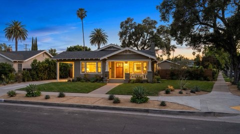 A single-family home exterior in Studio City with warm glowing windows at dusk