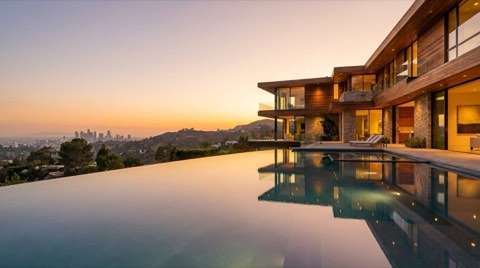 Hillside Los Angeles home with pool overlooking the hills at dusk