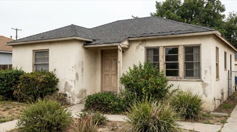 A structurally solid traditional Beverlywood home showing visible signs of needing updates under overcast daylight