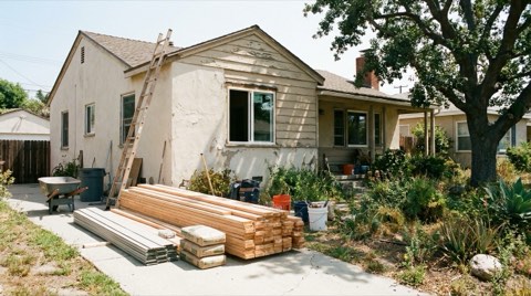 A single-family home in Studio City undergoing light renovation with a ladder and building materials in the driveway