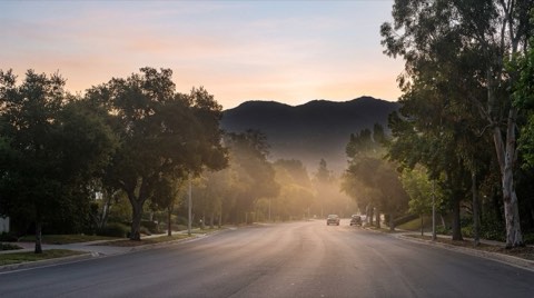 A quiet hazy morning road in Studio City leading toward the entrance of Cahuenga Pass