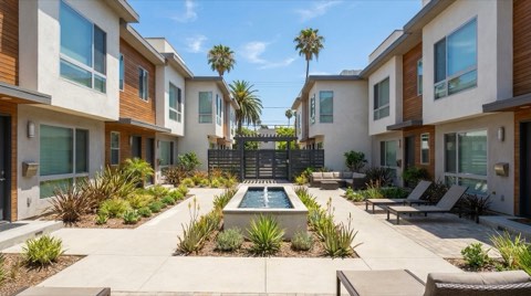A well-kept condominium complex courtyard in Studio City at midday with landscaped common areas