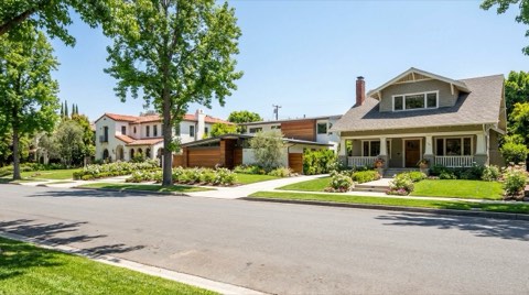 An upscale row of single-family homes on a Studio City street under bright midday light