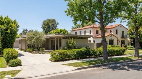 A Studio City street showing a mid-century modern home next to a Spanish revival style home