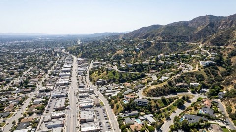 An elevated view over Studio City showing the transition from flatland streets to hillside terrain toward Mulholland Drive
