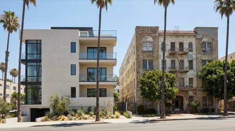 Two contrasting apartment buildings on the same block, one freshly renovated and one with original vintage character, in midday light