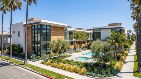 A modern Venice condominium building with a shared courtyard and pool