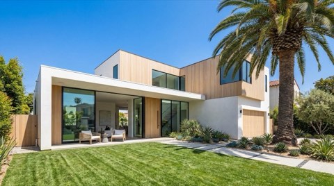 An upscale single-family home exterior in Venice under a clear blue sky