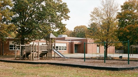 An elementary school building exterior with an empty playground near Mar Vista