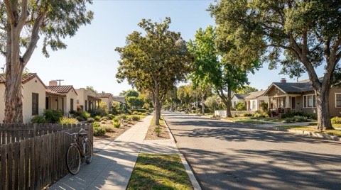 A quiet, tree-lined residential street in Santa Monica with tidy single-family homes in soft morning light