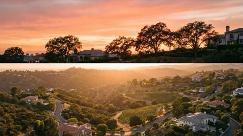 A romantic sunset over the rolling hillside estates of Bel Air, warm orange and pink sky silhouetting trees and rooftops