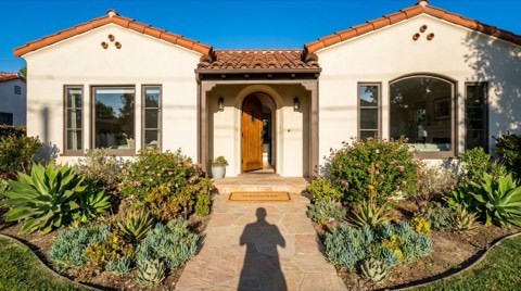 A traditional Beverlywood home exterior with a welcome mat at the front door in bright daylight